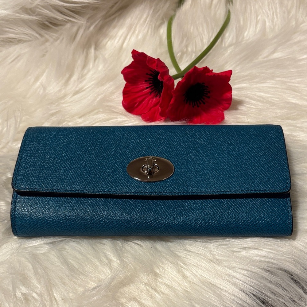 Coach Legacy Turnlock Wallet with purple insert.